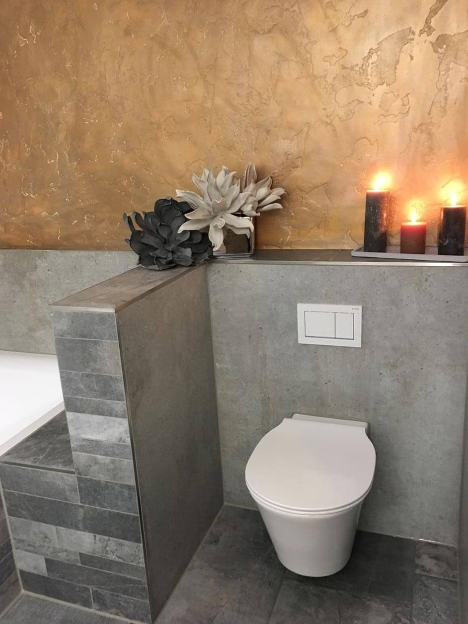 Sanitär John - modernes Badezimmer - Toilette & Badewanne mit Kerzen und Dekoration - Beton Optik